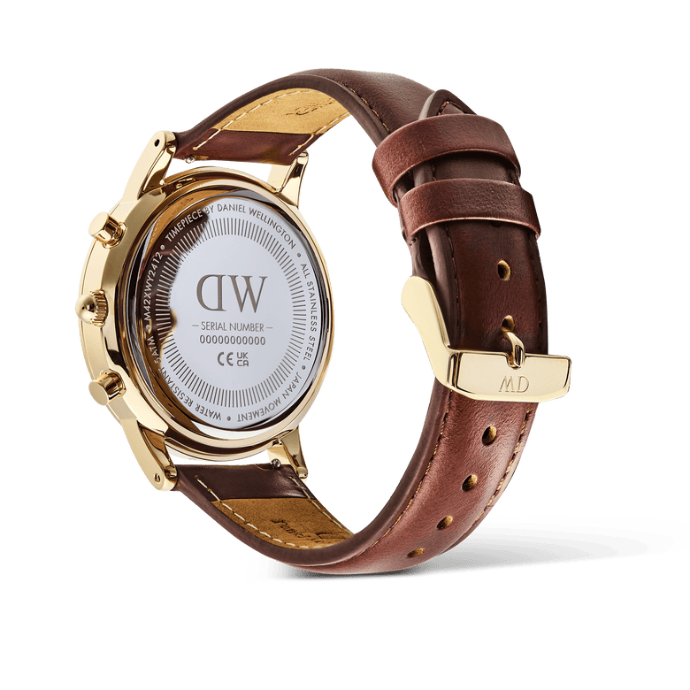 Detail of the Daniel Wellington Iconic Chronograph St Mawes Gold watch, showing the engraved caseback and brown leather strap.