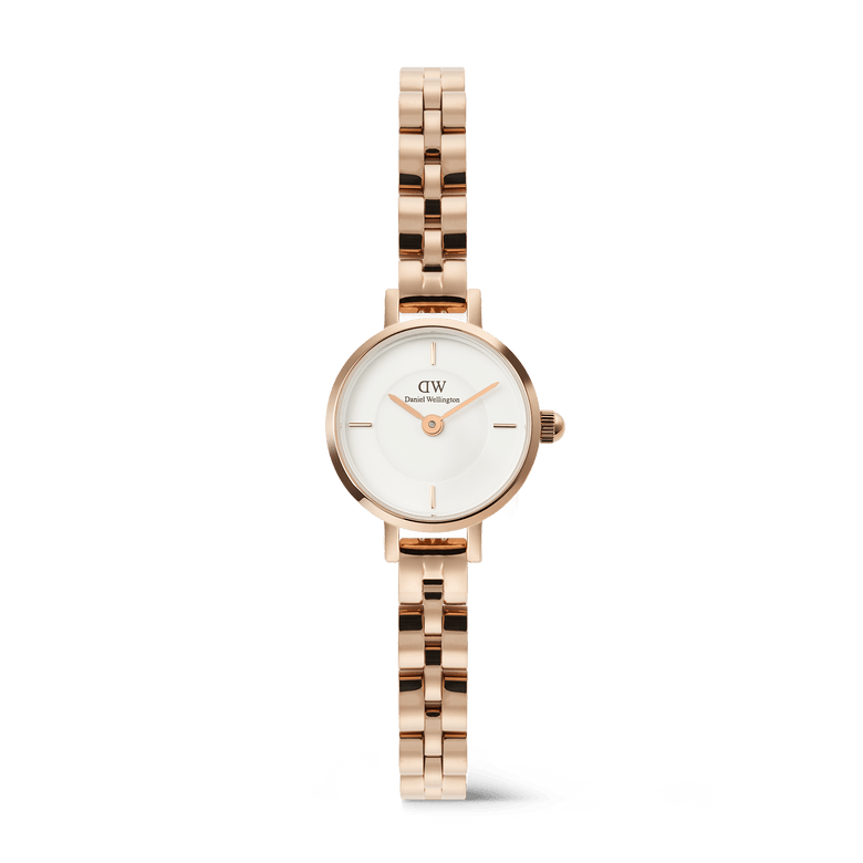 Daniel Wellington Petite Mini Arch watch with a white dial and a rose gold 3-link bracelet.