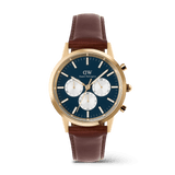 Daniel Wellington Iconic Chronograph St Mawes watch with an arctic blue panda dial, gold case, and brown leather strap.