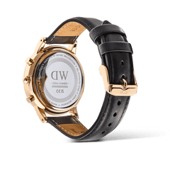 Rear view of the Daniel Wellington Iconic Chronograph watch, showing the engraved rose gold case back and the black leather strap with a rose gold pin buckle.