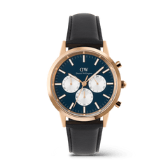 Daniel Wellington Iconic Chronograph watch in rose gold with an arctic blue dial, three white sub-dials, and a black leather strap.