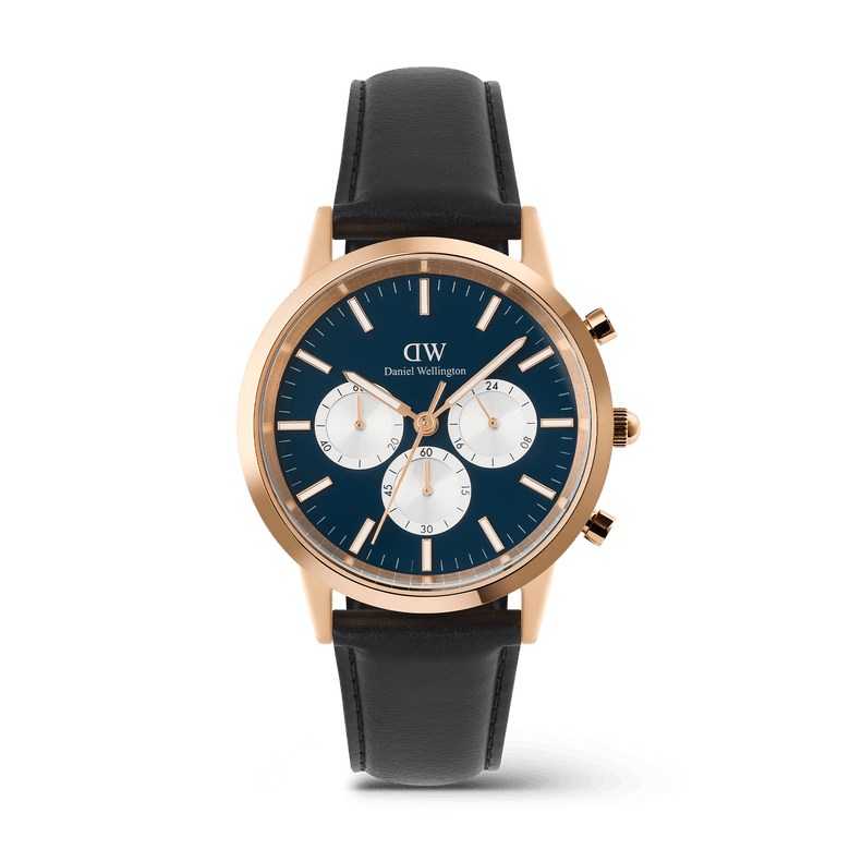 Daniel Wellington Iconic Chronograph watch in rose gold with an arctic blue dial, three white sub-dials, and a black leather strap.