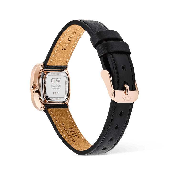 Close-up of the back of the Daniel Wellington Margot Sheffield watch, showing the engraved rose gold caseback and the black genuine leather strap with its matching pin buckle.