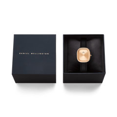 Daniel Wellington Margot Sheffield Unitone watch in rose gold with a black leather strap, displayed in its signature black presentation box.